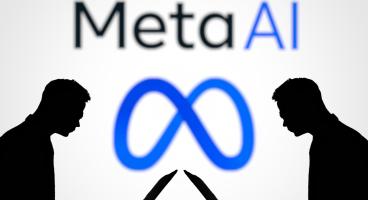 Two people sitting at laptops. In the background you can see the Meta logo and the slogan "Meta AI".